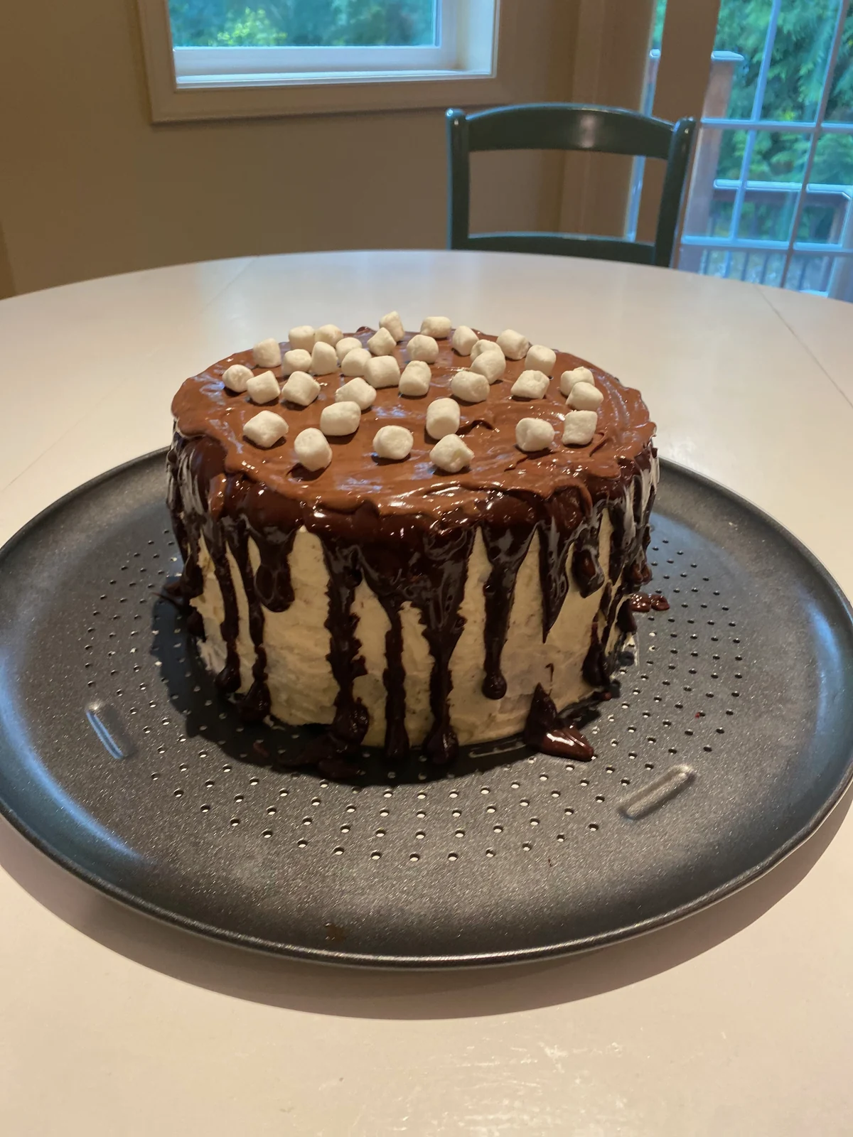 Complete cake with pale side frosting, chocolate ganache and mini white marshmallows.