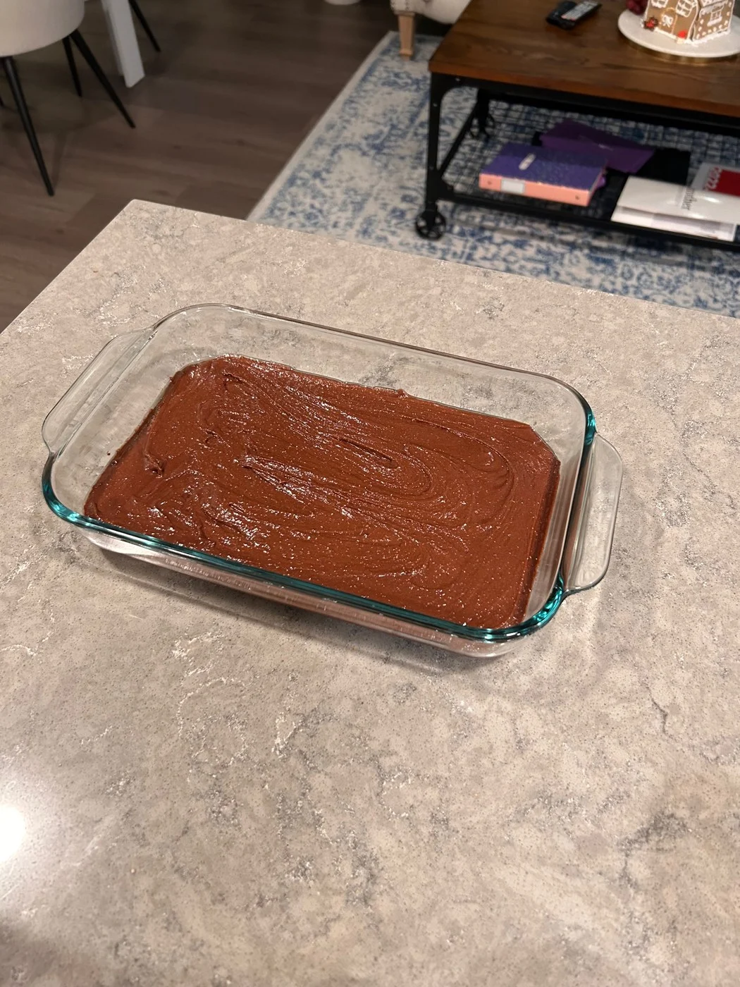 Smooth chocolate batter spread in a rectangular glass baking dish.