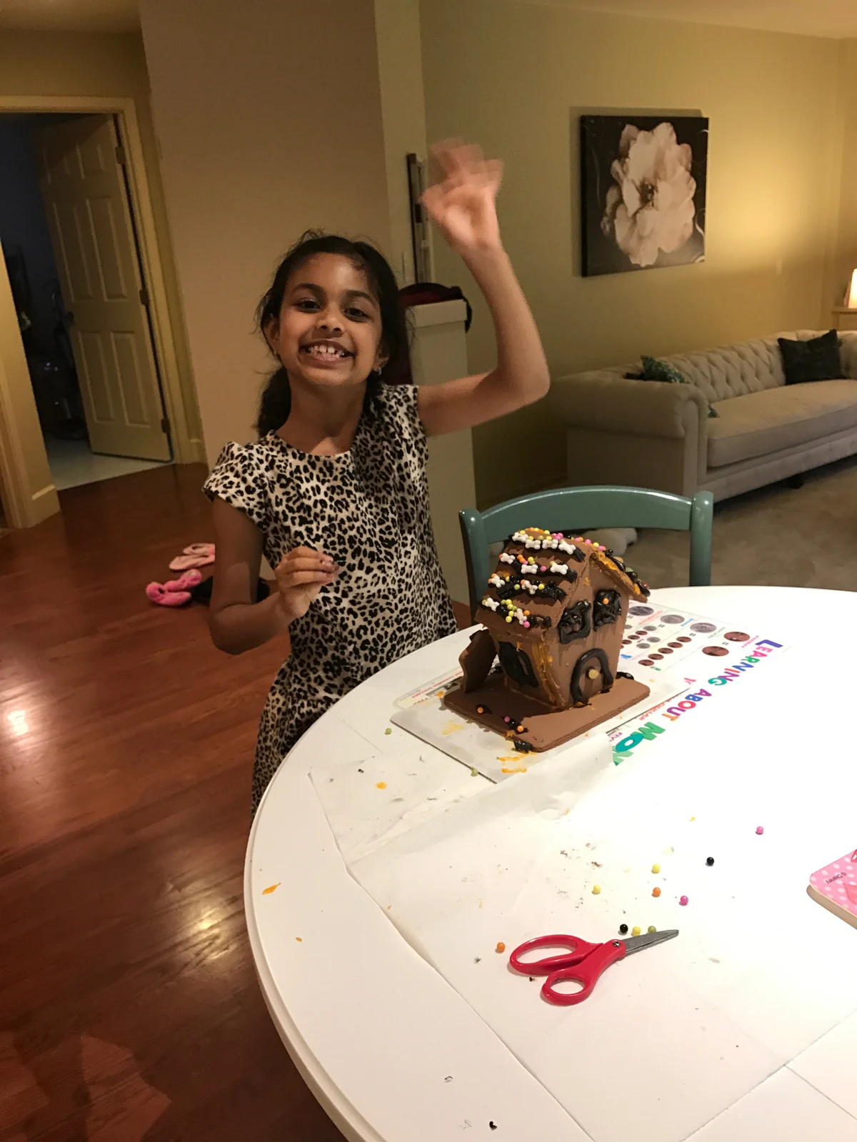 Another portrait with the same small cookie house as 009; distinct pose and view.