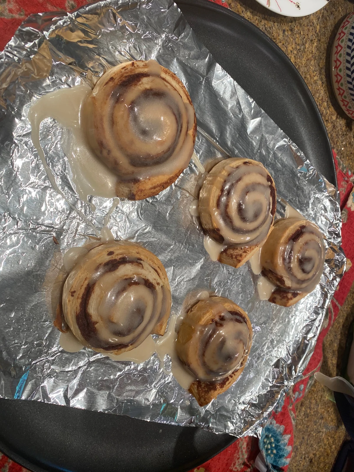 Overhead view of same five glazed spiral buns.